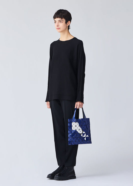 A model wears the BAO BAO ISSEY MIYAKE WONDER tote.