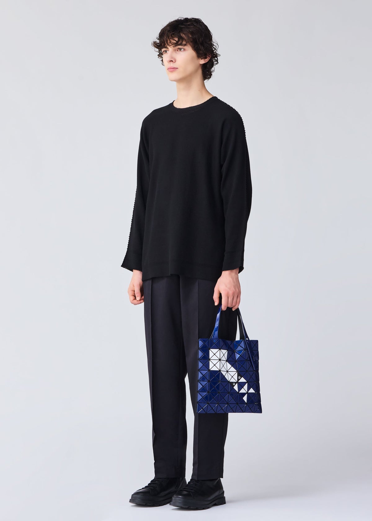A model wears the BAO BAO ISSEY MIYAKE WONDER tote.