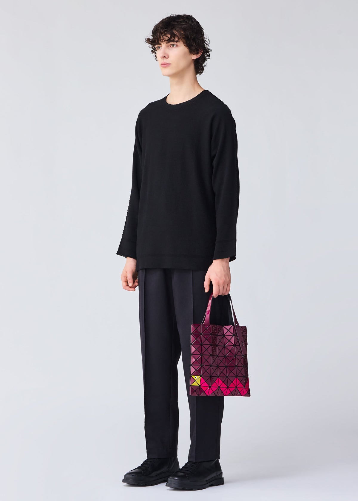 A model wears the BAO BAO ISSEY MIYAKE WONDER tote.