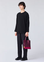 A model wears the BAO BAO ISSEY MIYAKE WONDER tote.