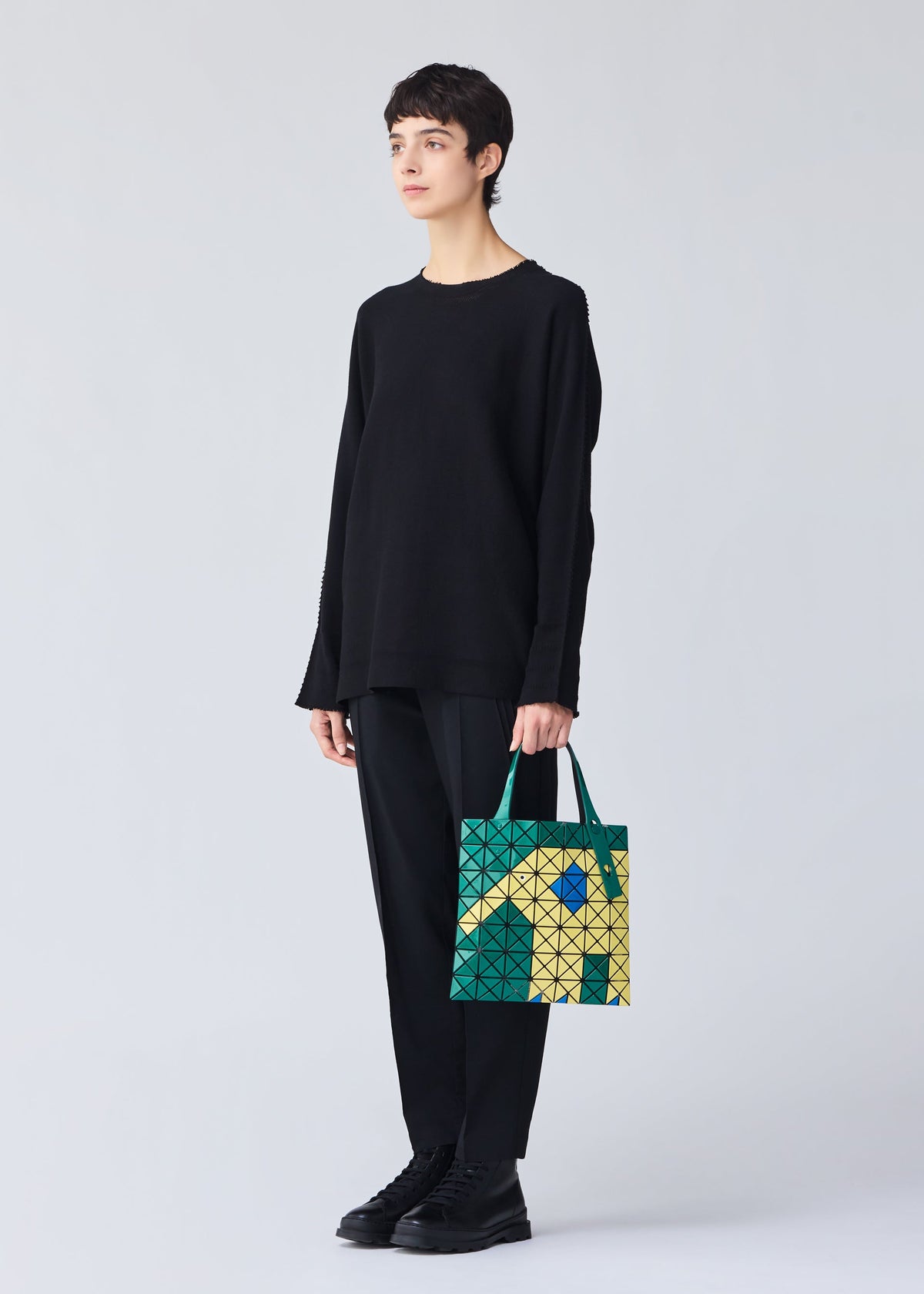 A model wears the BAO BAO ISSEY MIYAKE WONDER tote.