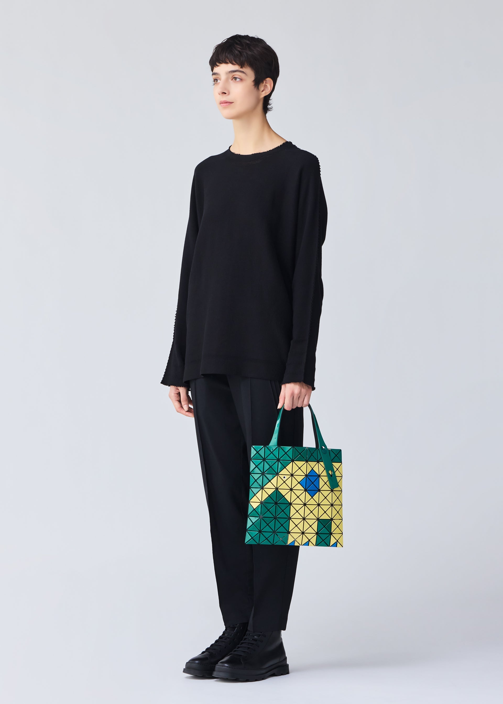 A model wears the BAO BAO ISSEY MIYAKE WONDER tote.
