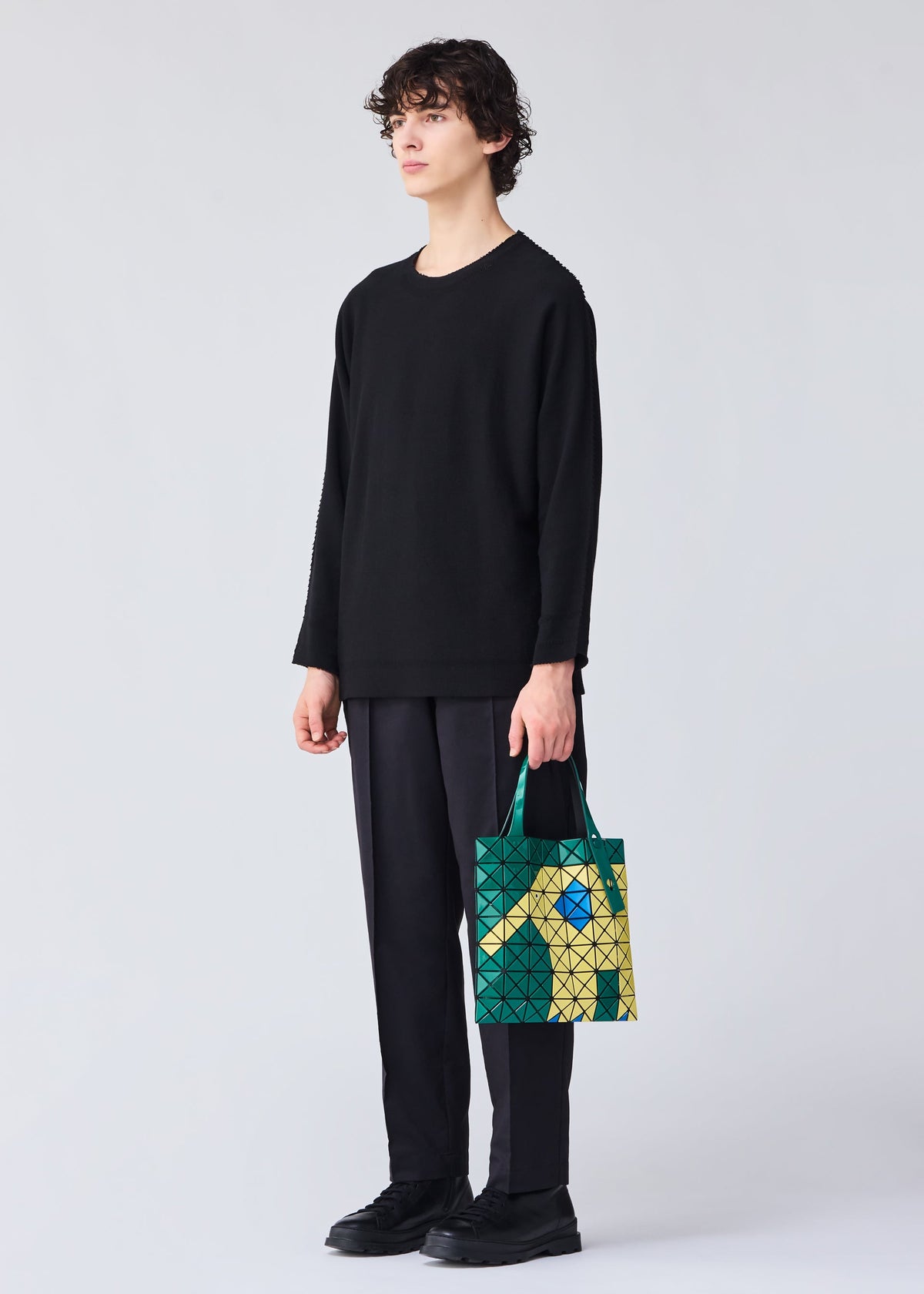 A model wears the BAO BAO ISSEY MIYAKE WONDER tote.