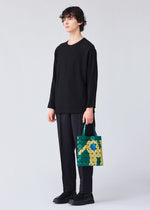 A model wears the BAO BAO ISSEY MIYAKE WONDER tote.