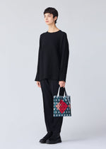 A model wears the BAO BAO ISSEY MIYAKE WONDER tote.