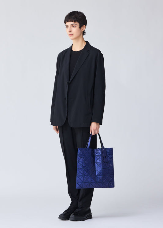 A model wears the BAO BAO ISSEY MIYAKE META KAIJU tote.