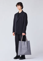 A model wears the BAO BAO ISSEY MIYAKE TRACK tote.