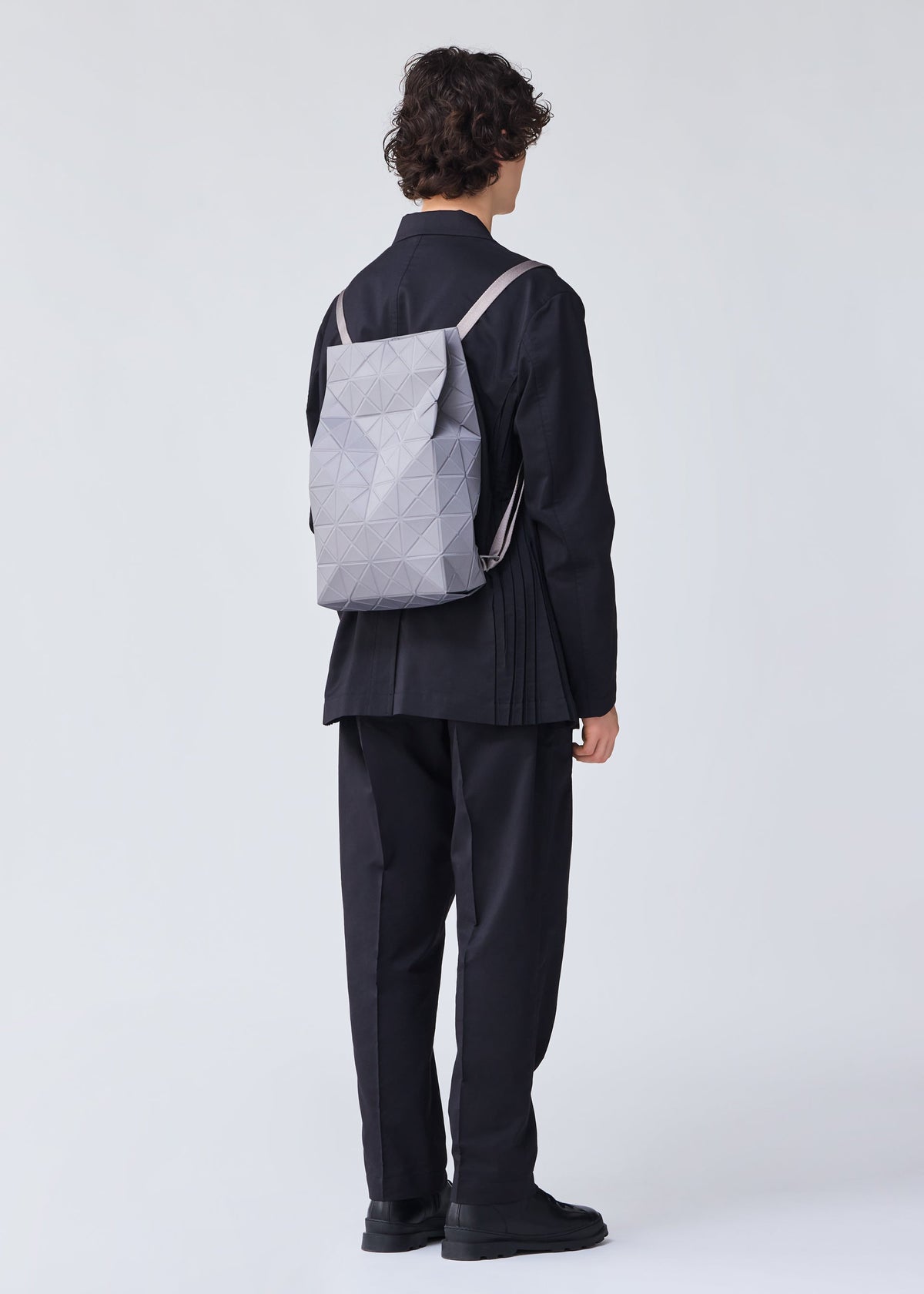 A model wears the BAO BAO ISSEY MIYAKE TRACK backpack.