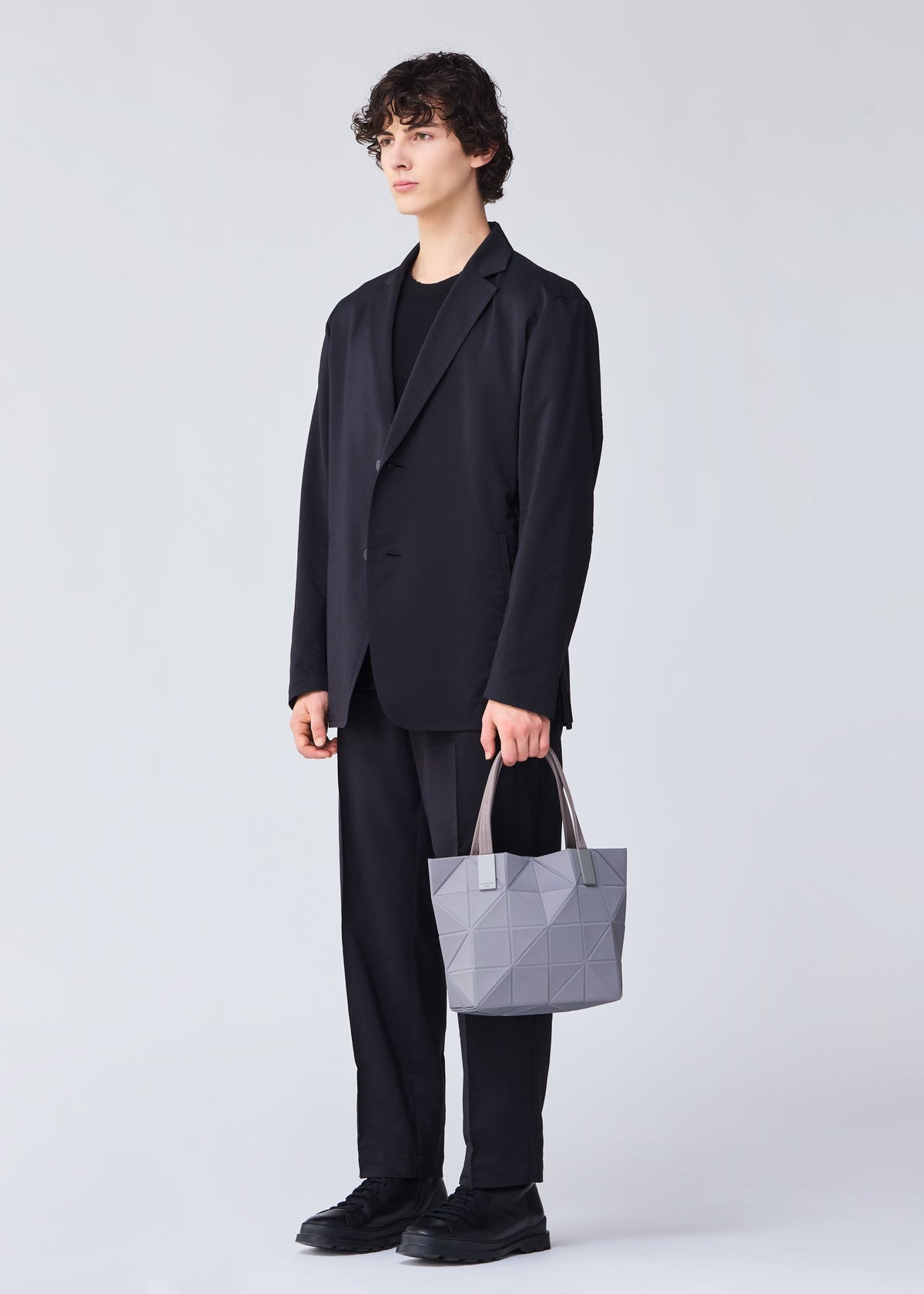 A model wears the BAO BAO ISSEY MIYAKE TRACK 0.