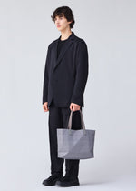 A model wears the BAO BAO ISSEY MIYAKE TRACK 0.