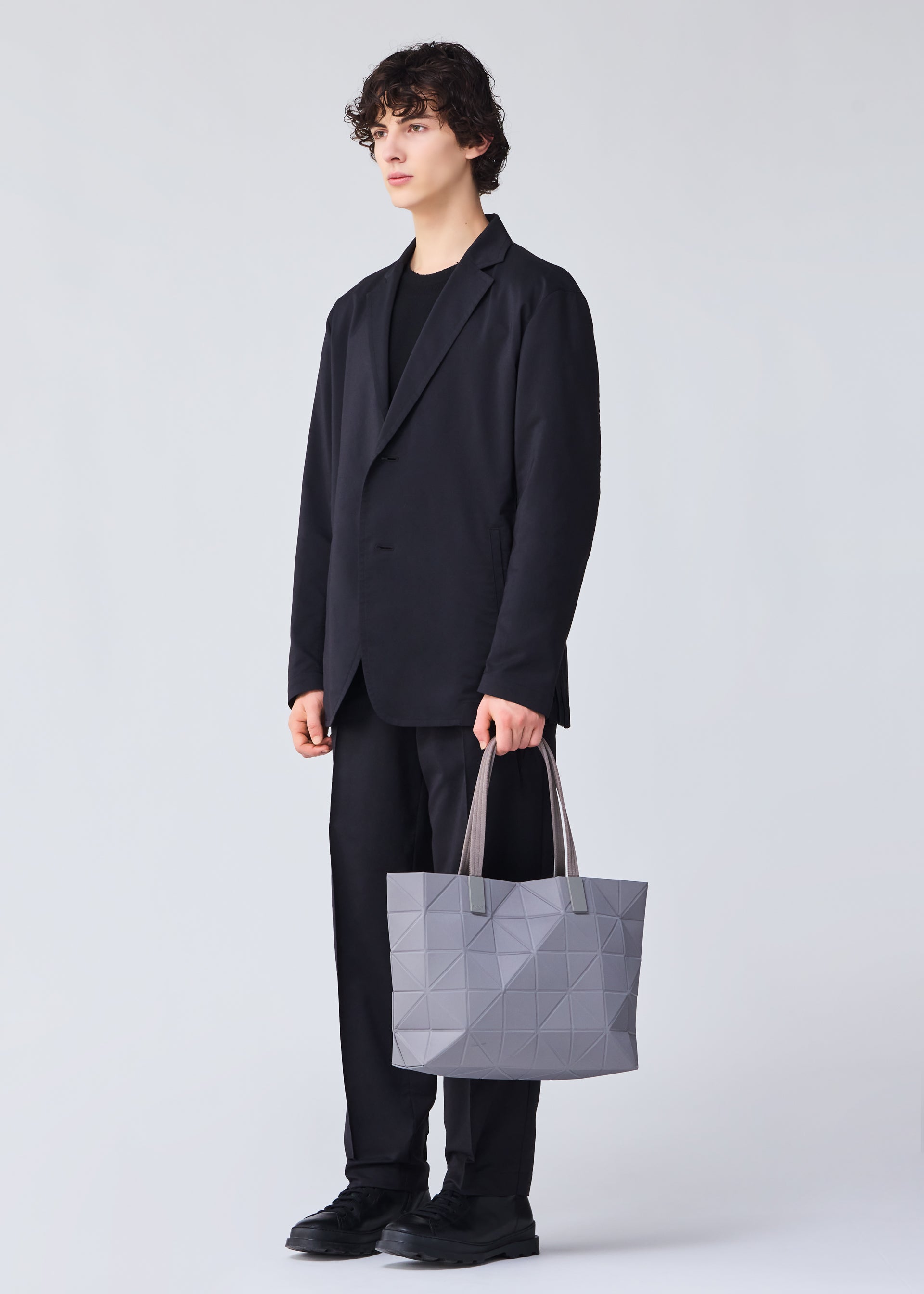 A model wears the BAO BAO ISSEY MIYAKE TRACK 0.