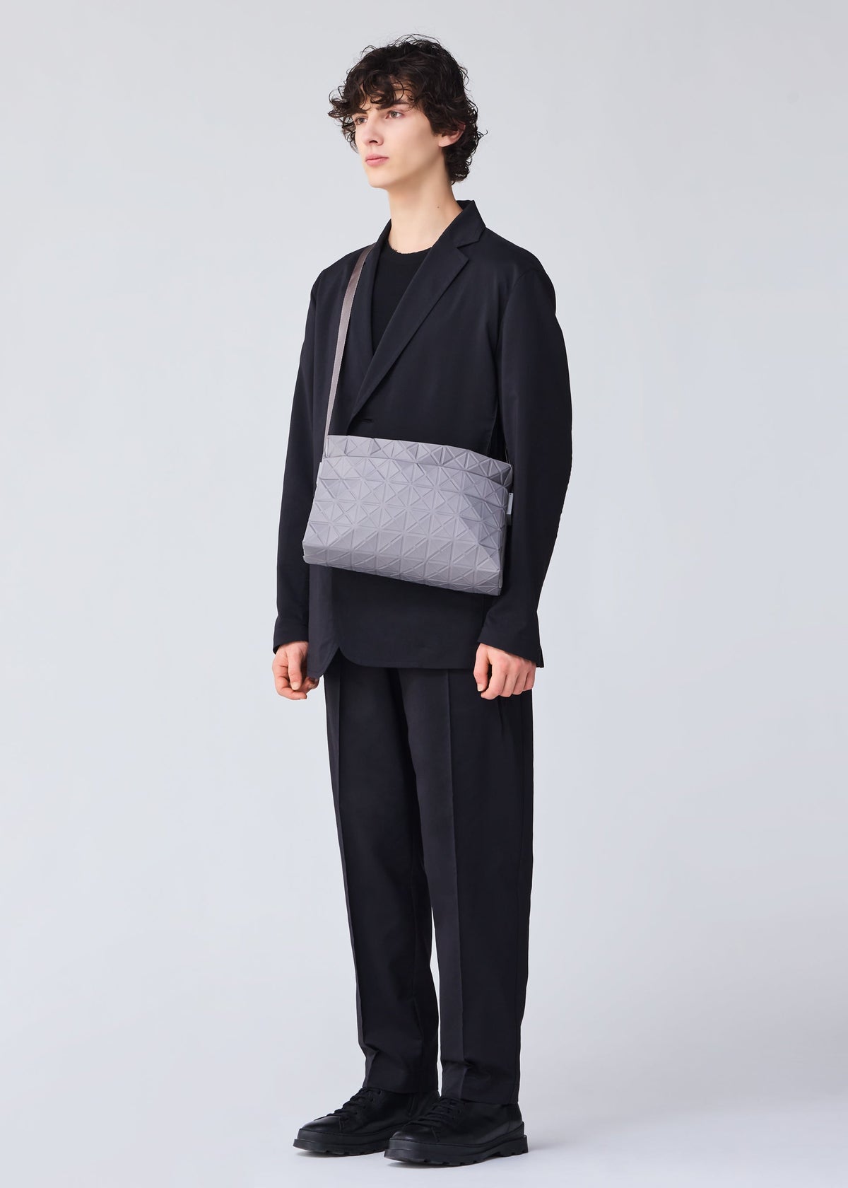 A model wears the BAO BAO ISSEY MIYAKE TRACK shoulder bag.