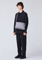 A model wears the BAO BAO ISSEY MIYAKE TRACK shoulder bag.