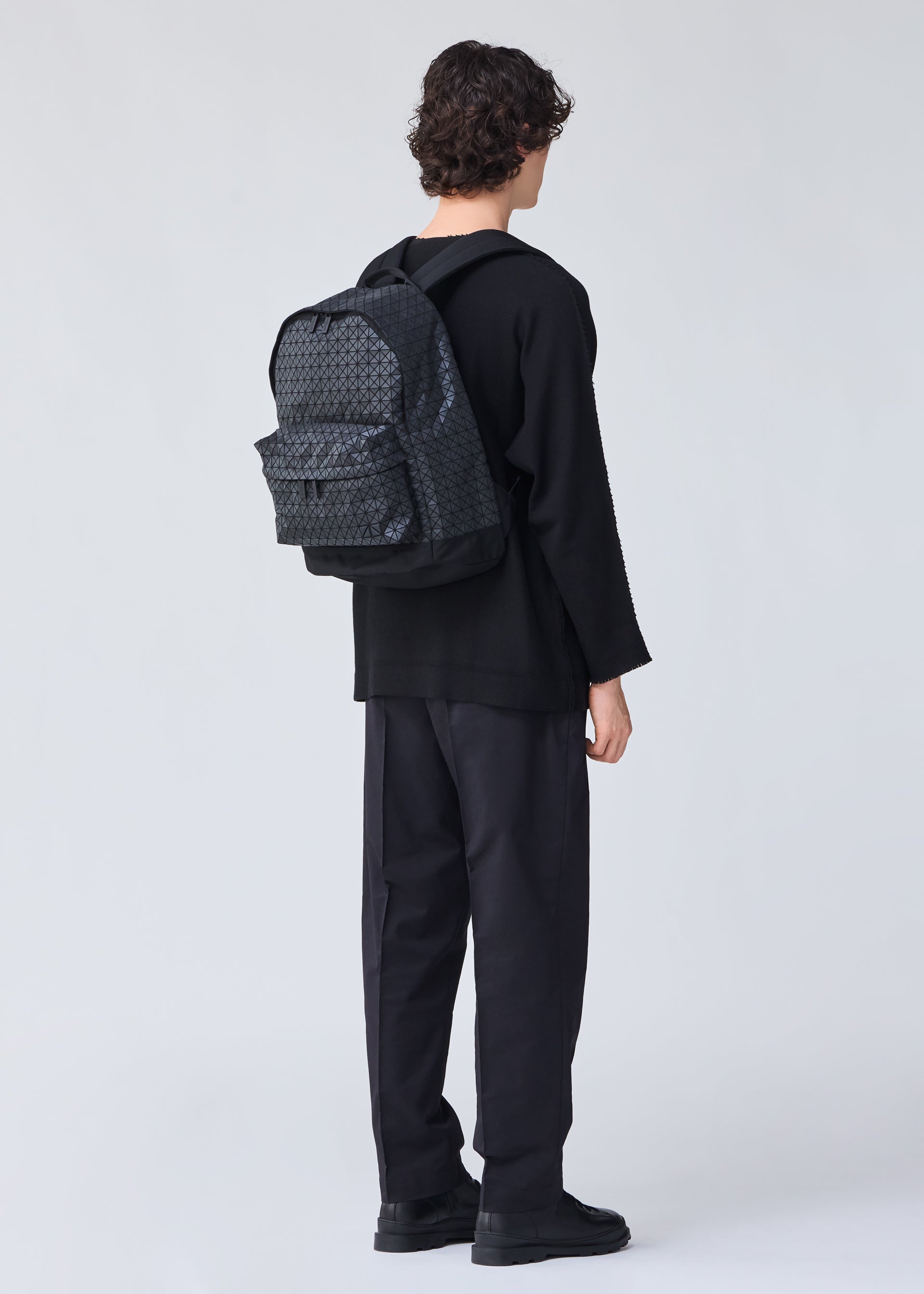 A model wears the BAO BAO ISSEY MIYAKE DAYPACK backpack.