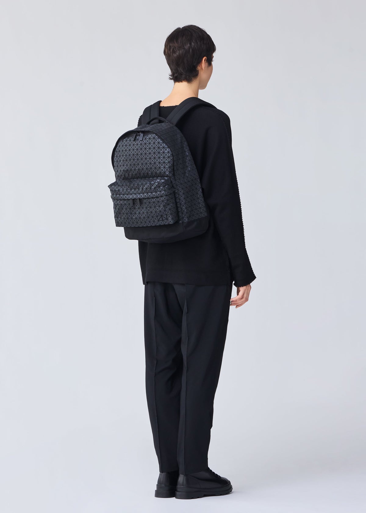 A model wears the BAO BAO ISSEY MIYAKE DAYPACK backpack.