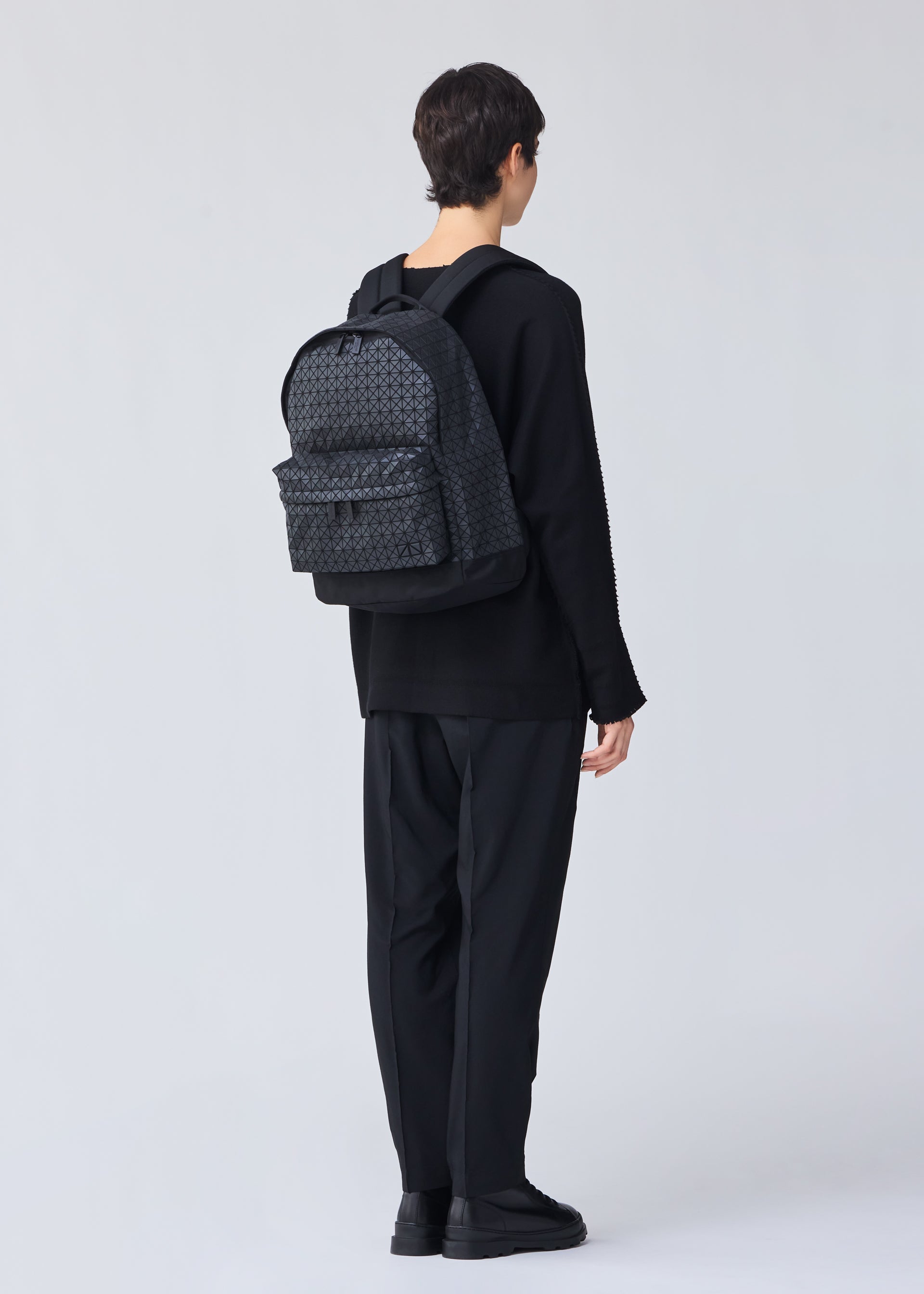 A model wears the BAO BAO ISSEY MIYAKE DAYPACK backpack.