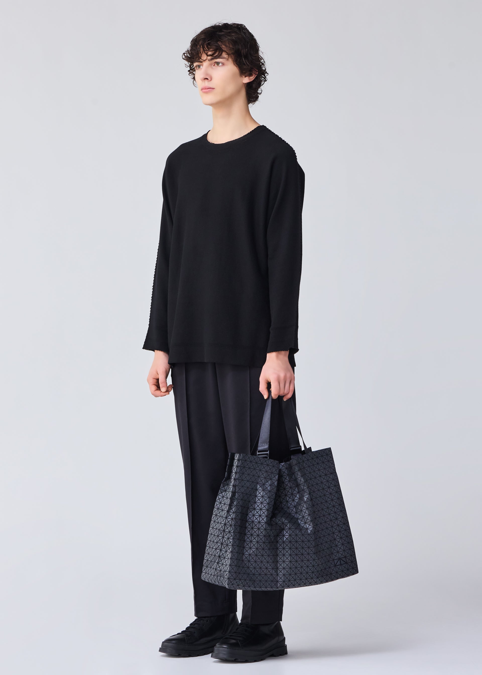 A model wears the BAO BAO ISSEY MIYAKE CART tote.
