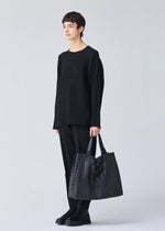 A model wears the BAO BAO ISSEY MIYAKE CART tote.