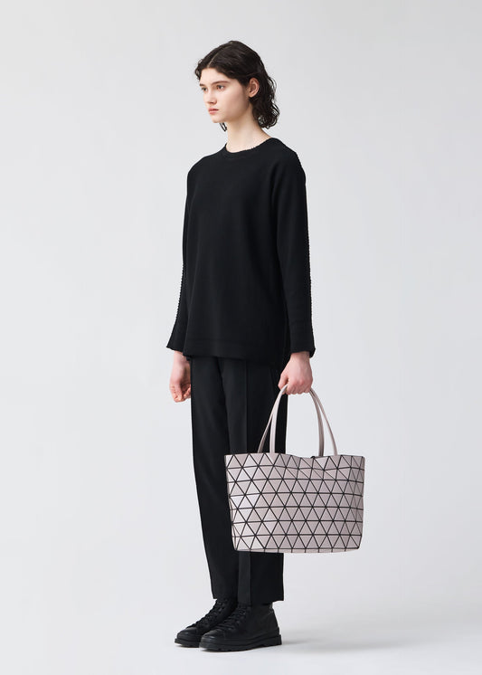 A model wears the BAO BAO ISSEY MIYAKE BATEAU tote.