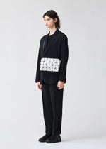 A model wears the BAO BAO ISSEY MIYAKE CARTON shoulder bag.