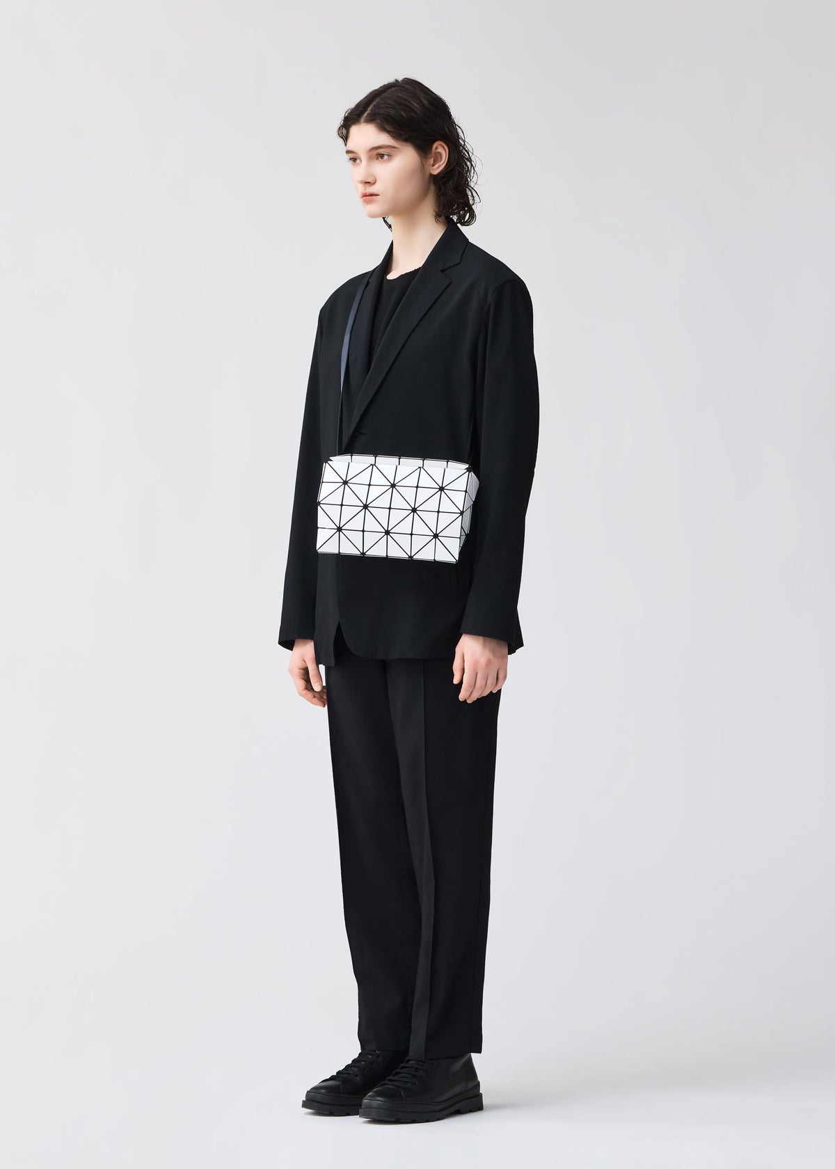 A model wears the BAO BAO ISSEY MIYAKE CARTON shoulder bag.