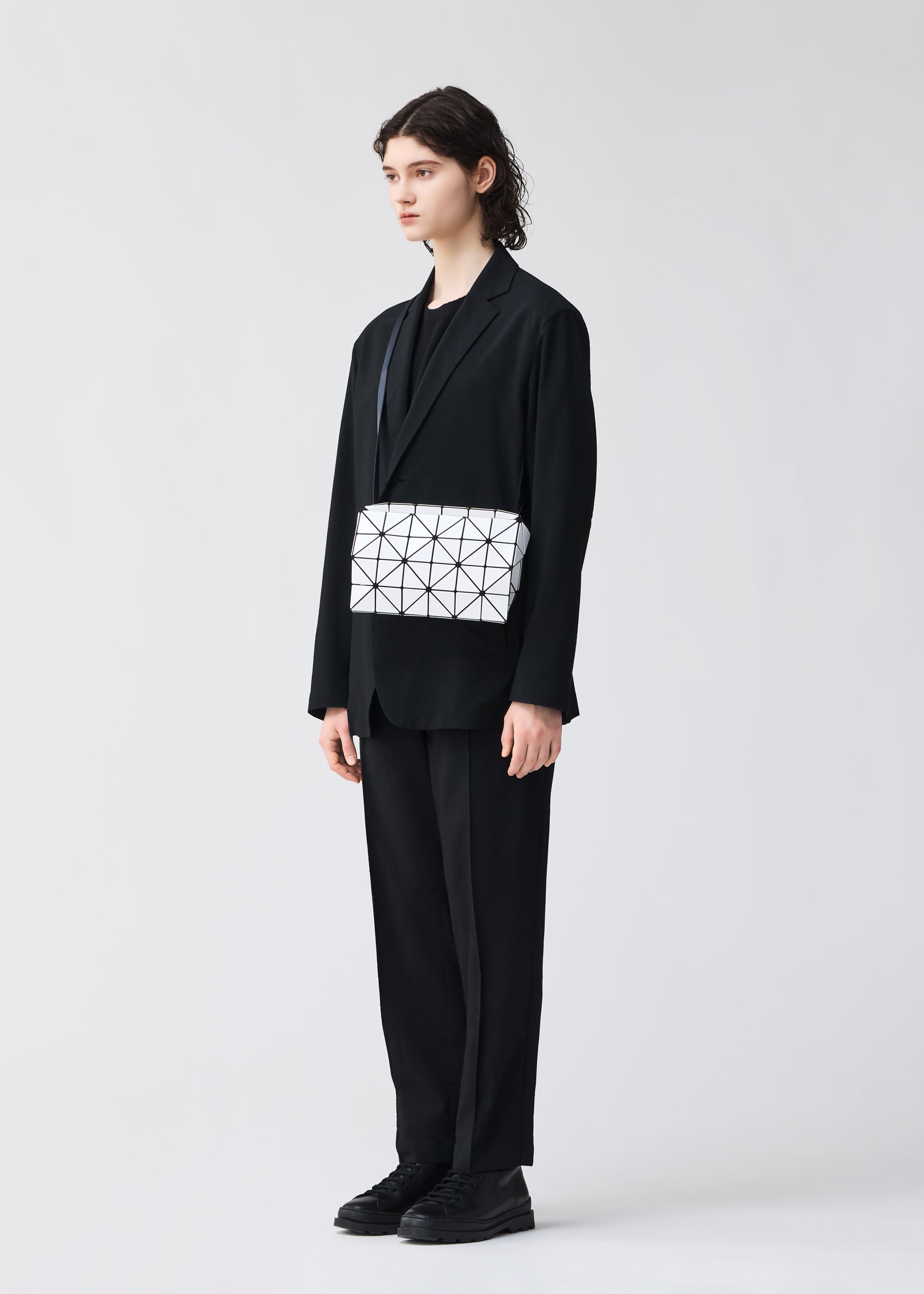 A model wears the BAO BAO ISSEY MIYAKE CARTON shoulder bag.