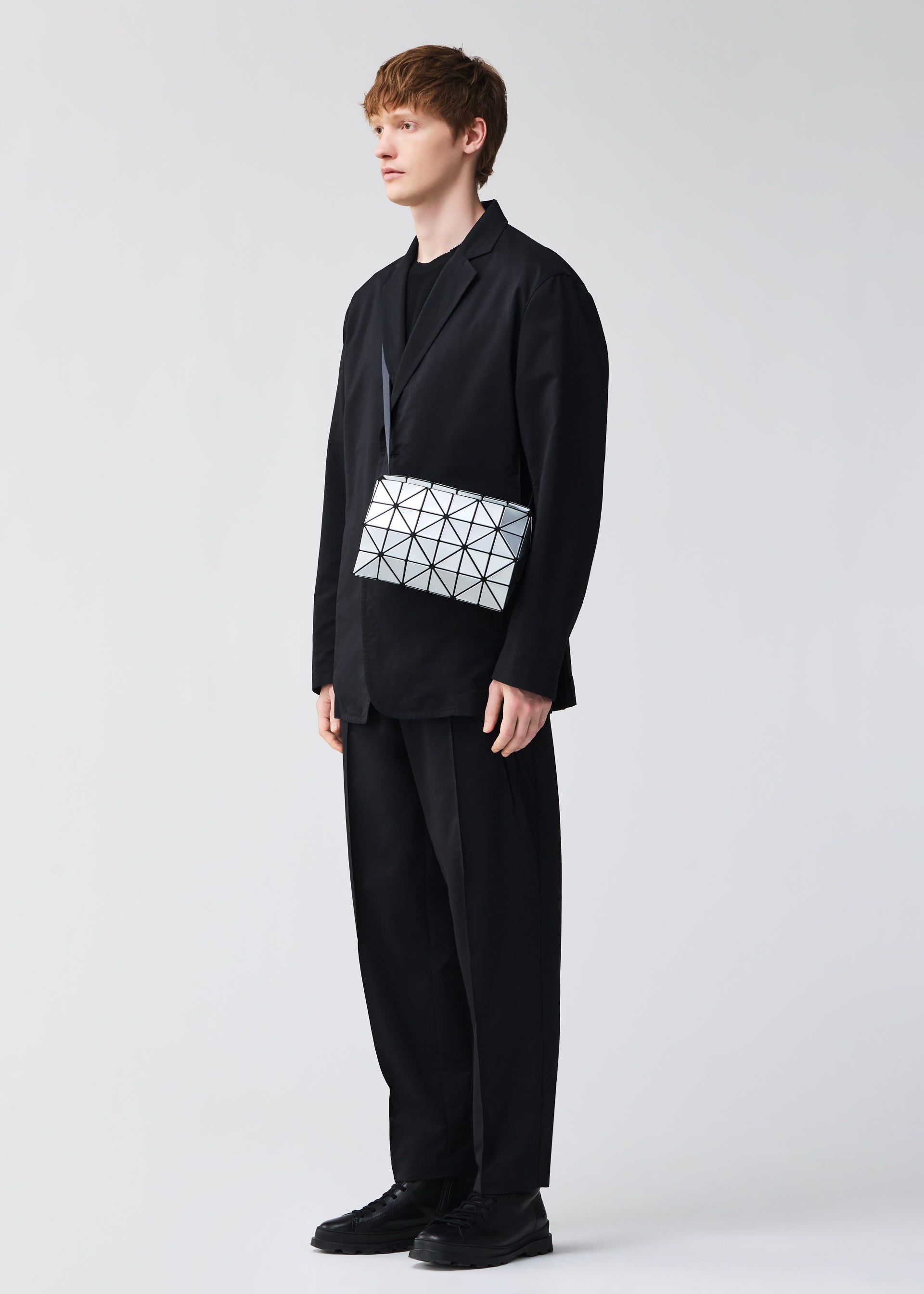 A model wears the BAO BAO ISSEY MIYAKE CARTON shoulder bag.