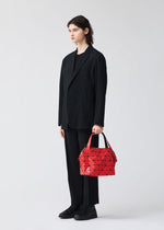 A model wears the BAO BAO ISSEY MIYAKE BOSTON hand bag.