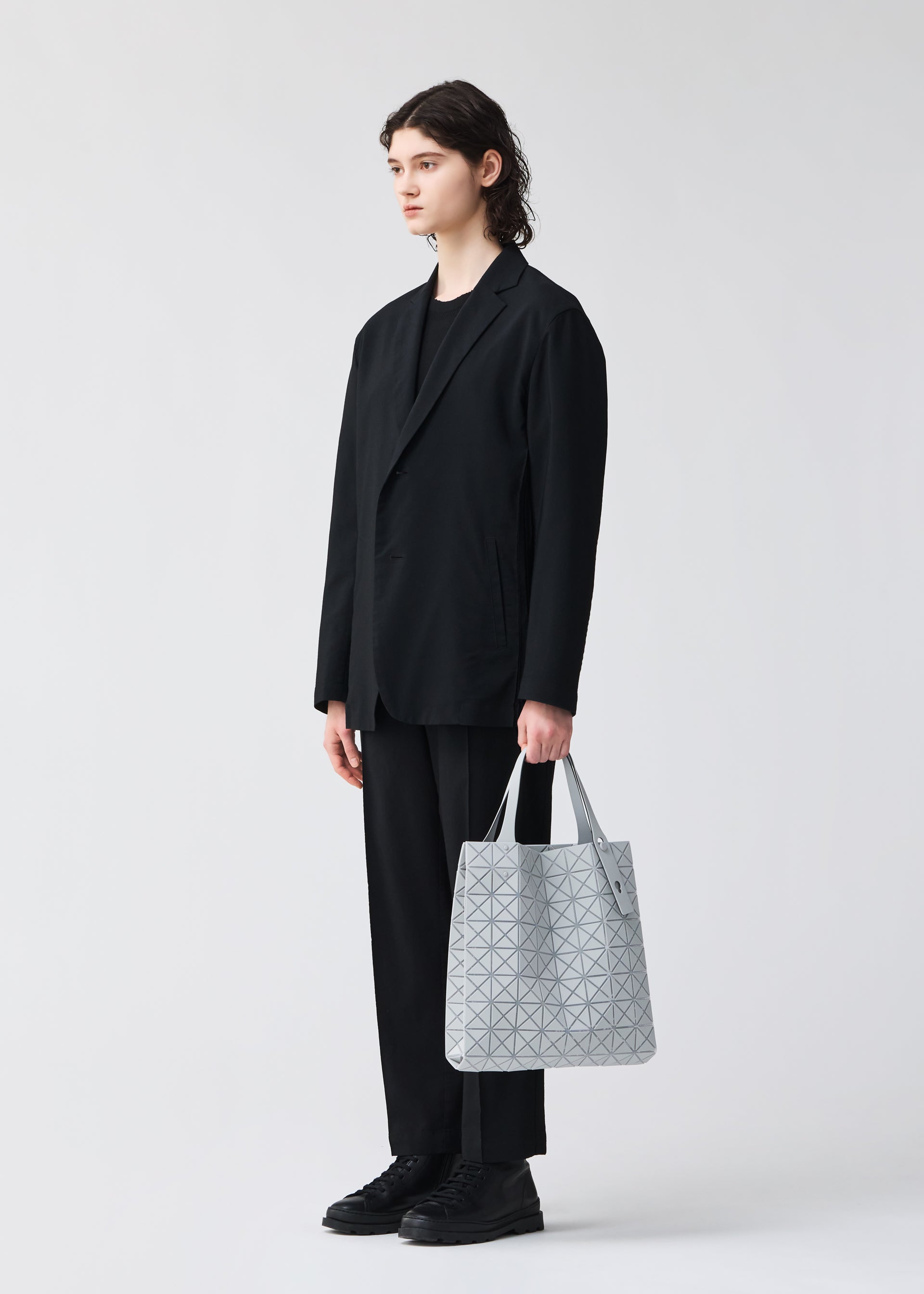 A model wears the BAO BAO ISSEY MIYAKE PRISM PLUS tote.
