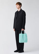 A model wears the BAO BAO ISSEY MIYAKE PRISM PLUS tote.