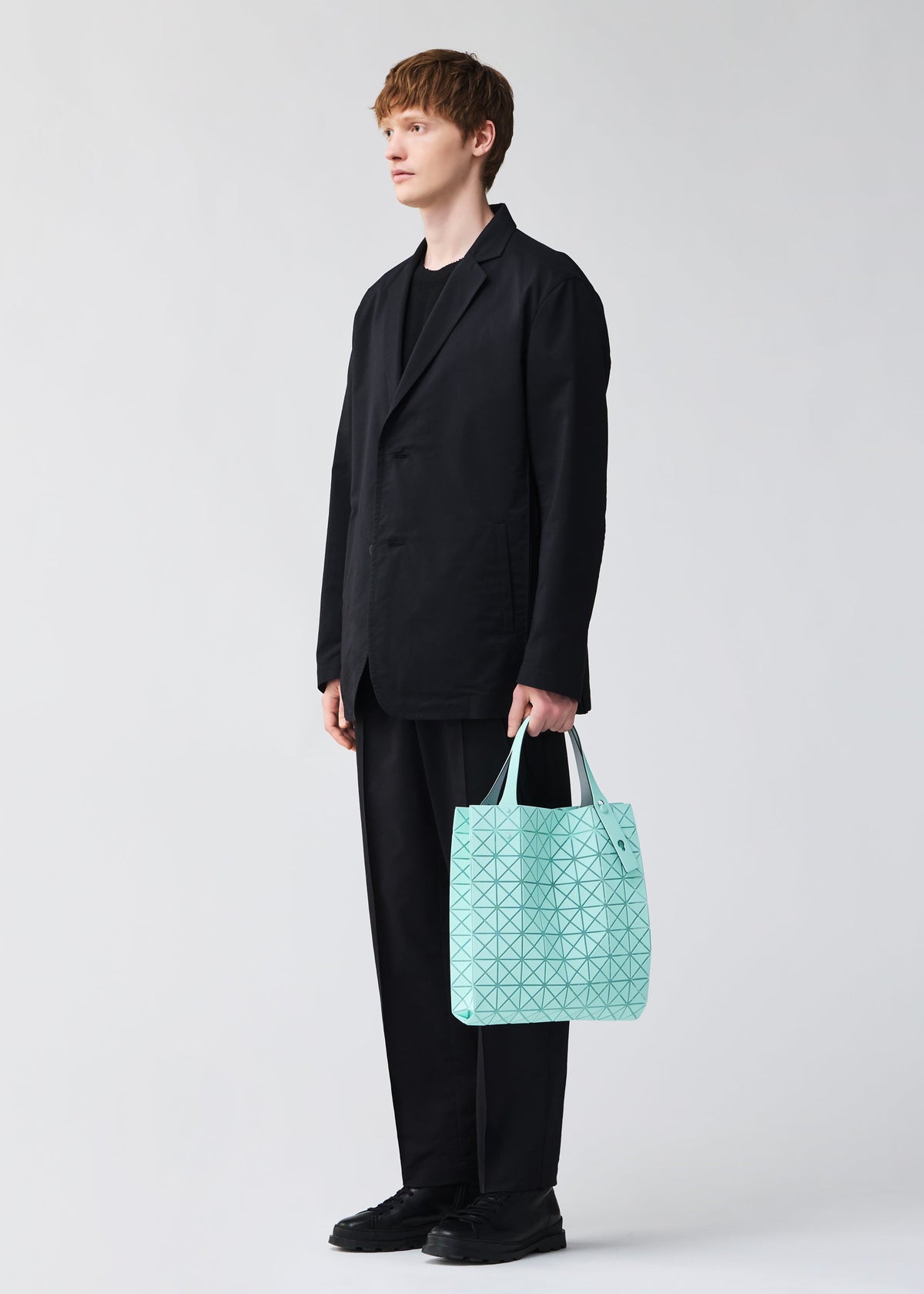 A model wears the BAO BAO ISSEY MIYAKE PRISM PLUS tote.