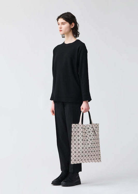 A model wears the BAO BAO ISSEY MIYAKE PRISM FROST tote.