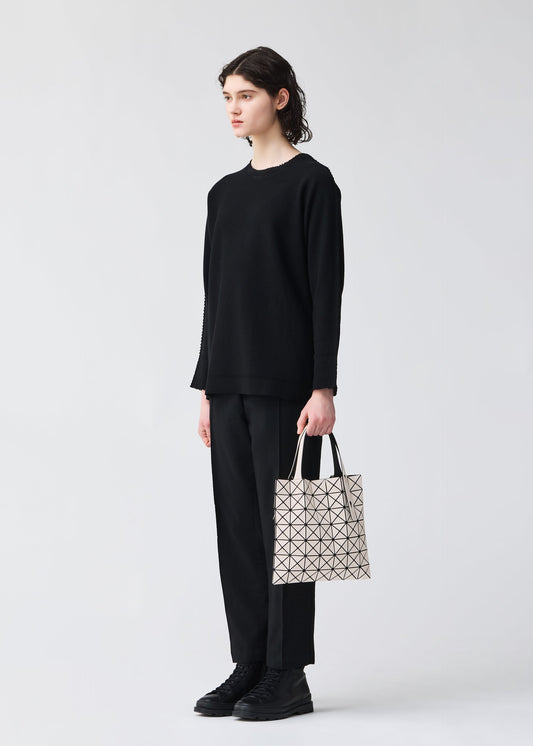 A model wears the BAO BAO ISSEY MIYAKE PRISM FROST tote.
