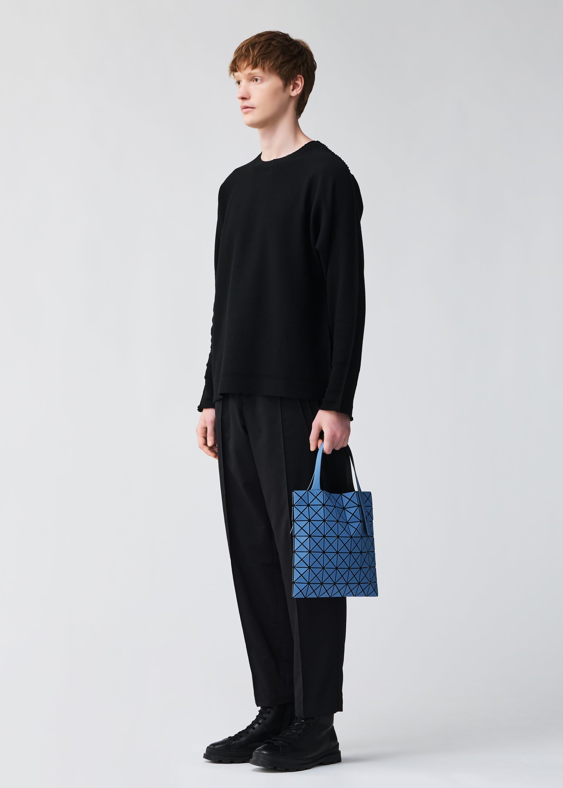 A model wears the BAO BAO ISSEY MIYAKE PRISM FROST tote.