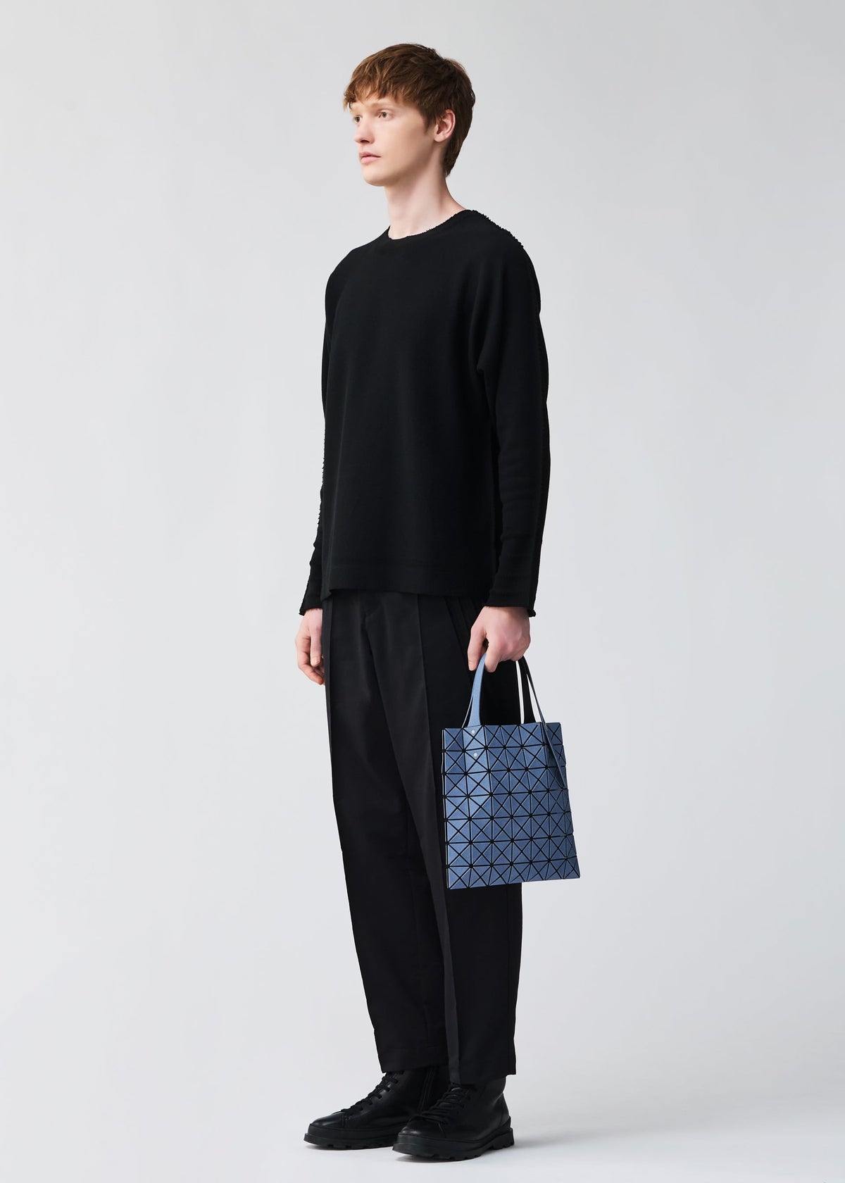 A model wears the BAO BAO ISSEY MIYAKE PRISM DENIM prism-denim-tote-black-1.