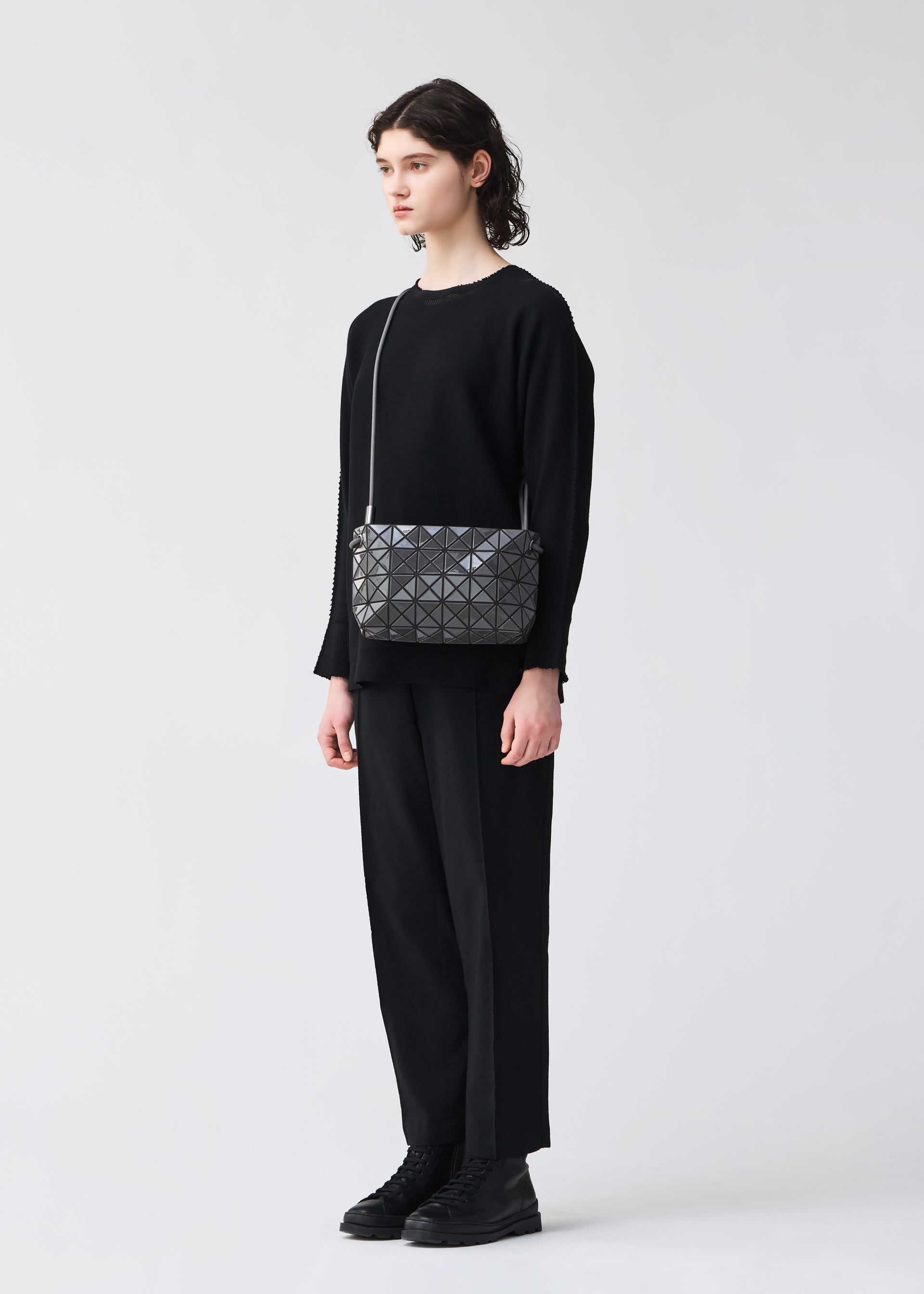A model wears the BAO BAO ISSEY MIYAKE LOOP ONE TONE shoulder bag.