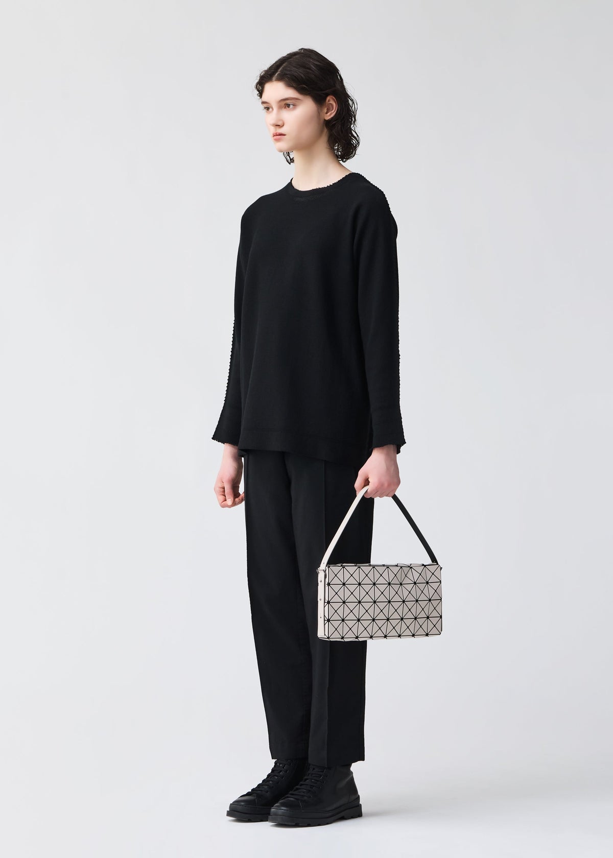 A model wears the BAO BAO ISSEY MIYAKE OBLONG oblong-shoulder-bag-khaki-1.