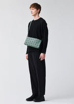 A model wears the BAO BAO ISSEY MIYAKE OBLONG oblong-shoulder-bag-matte-black-1.