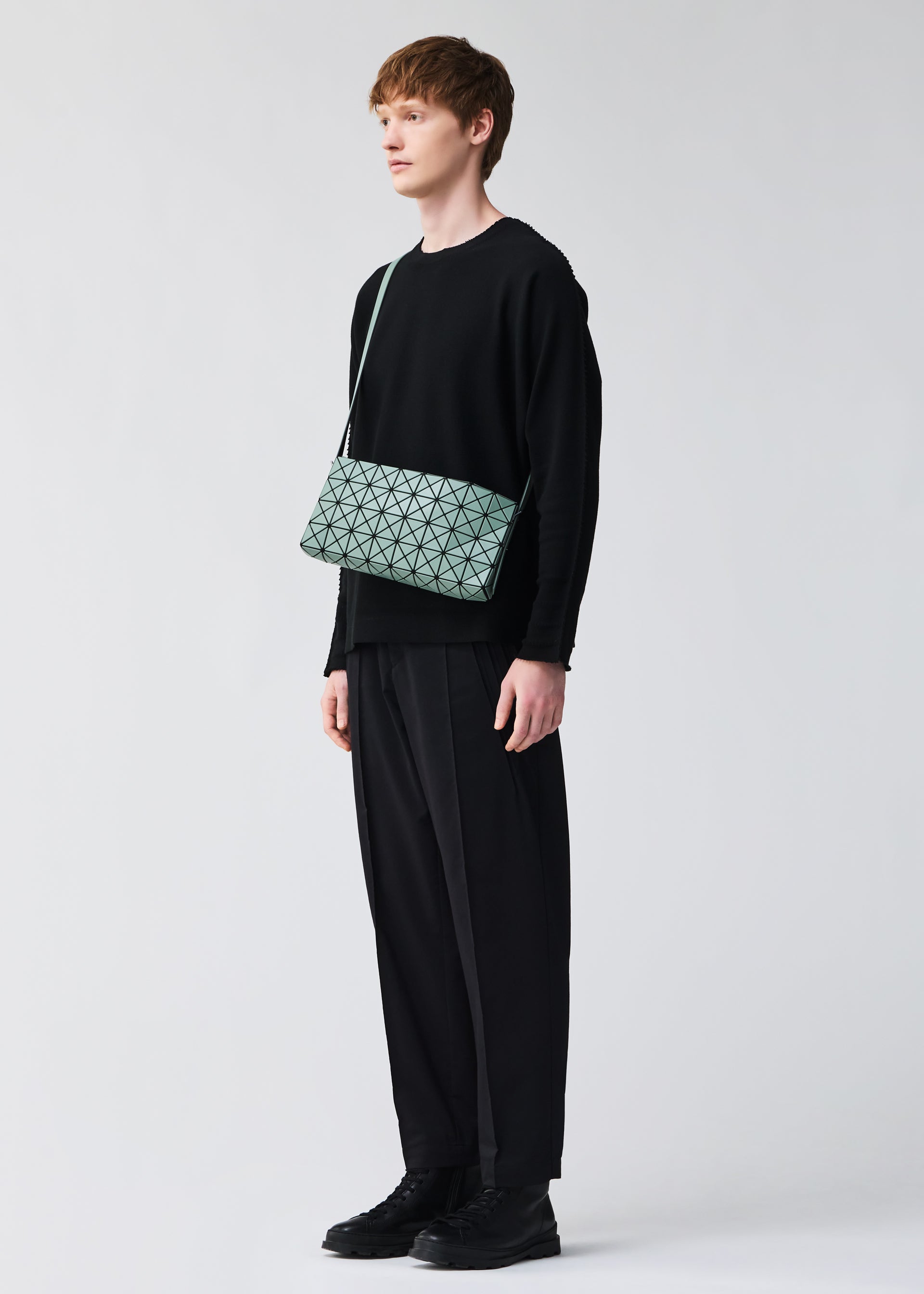 A model wears the BAO BAO ISSEY MIYAKE OBLONG oblong-shoulder-bag-beige-1.