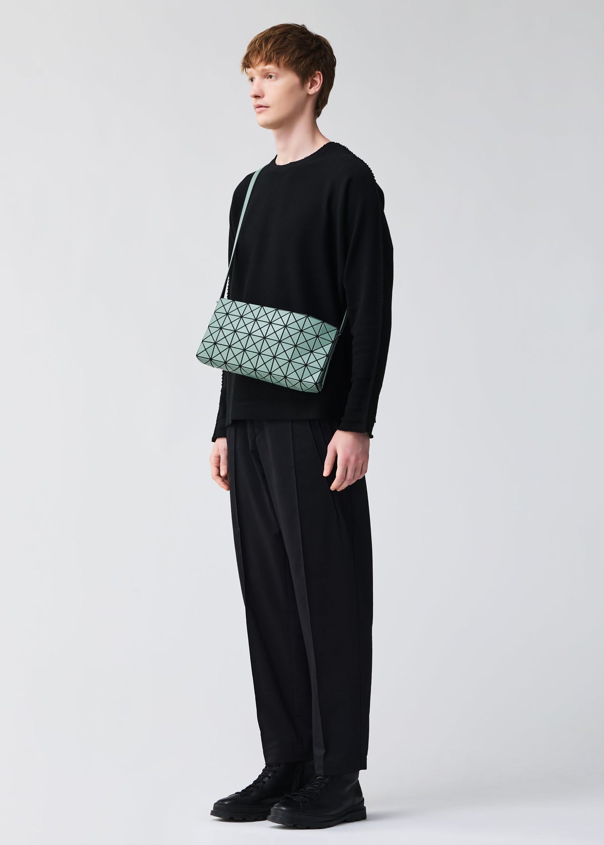 A model wears the BAO BAO ISSEY MIYAKE OBLONG oblong-shoulder-bag-khaki-1.