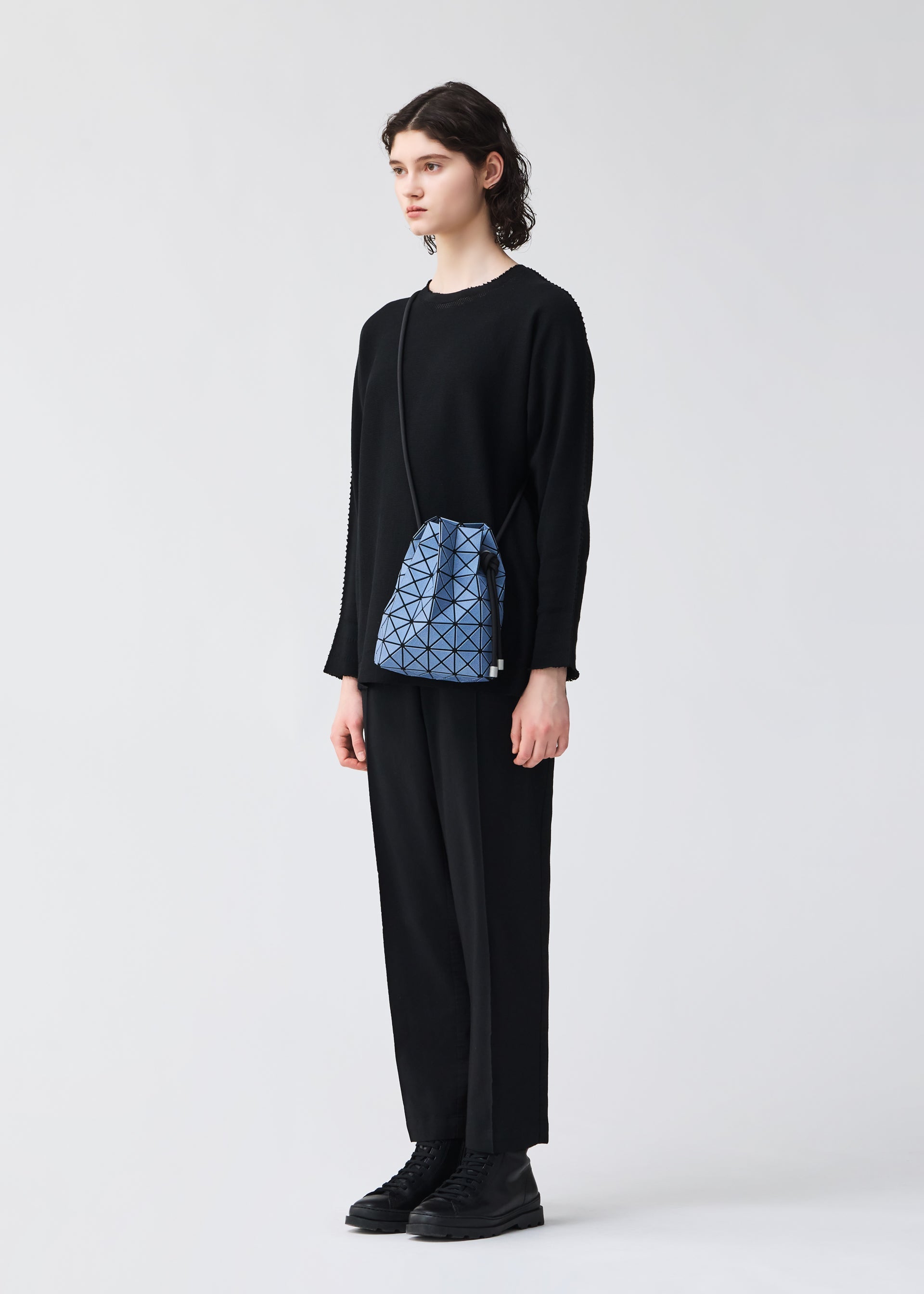 A model wears the BAO BAO ISSEY MIYAKE WRING DENIM wring-denim-shoulder-bag-black.