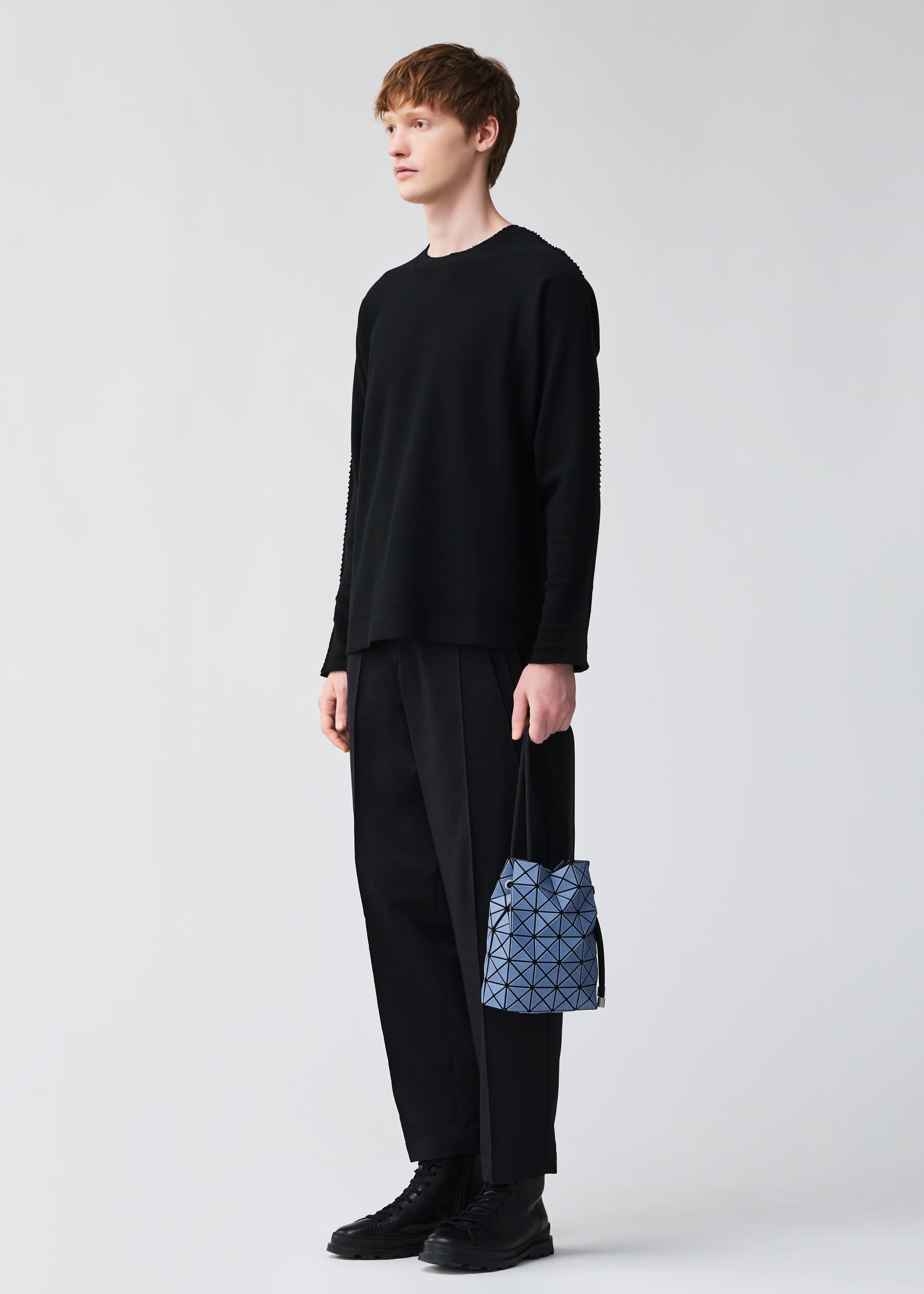 A model wears the BAO BAO ISSEY MIYAKE WRING DENIM wring-denim-shoulder-bag-black.