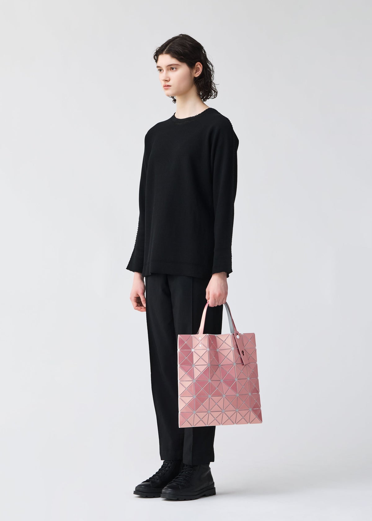 A model wears the BAO BAO ISSEY MIYAKE LUCENT METALLIC tote.