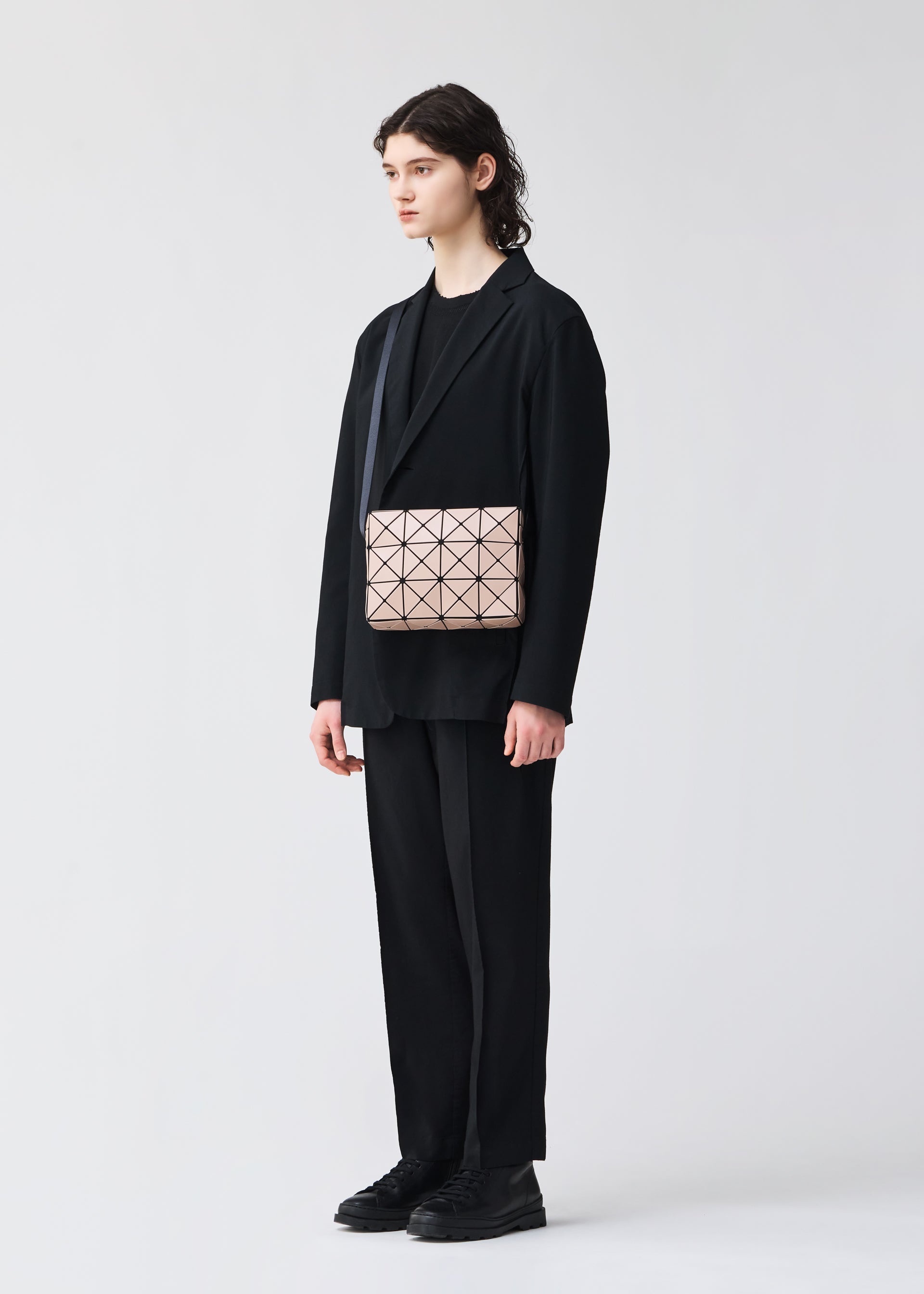 A model wears the BAO BAO ISSEY MIYAKE CUBOID shoulder bag.