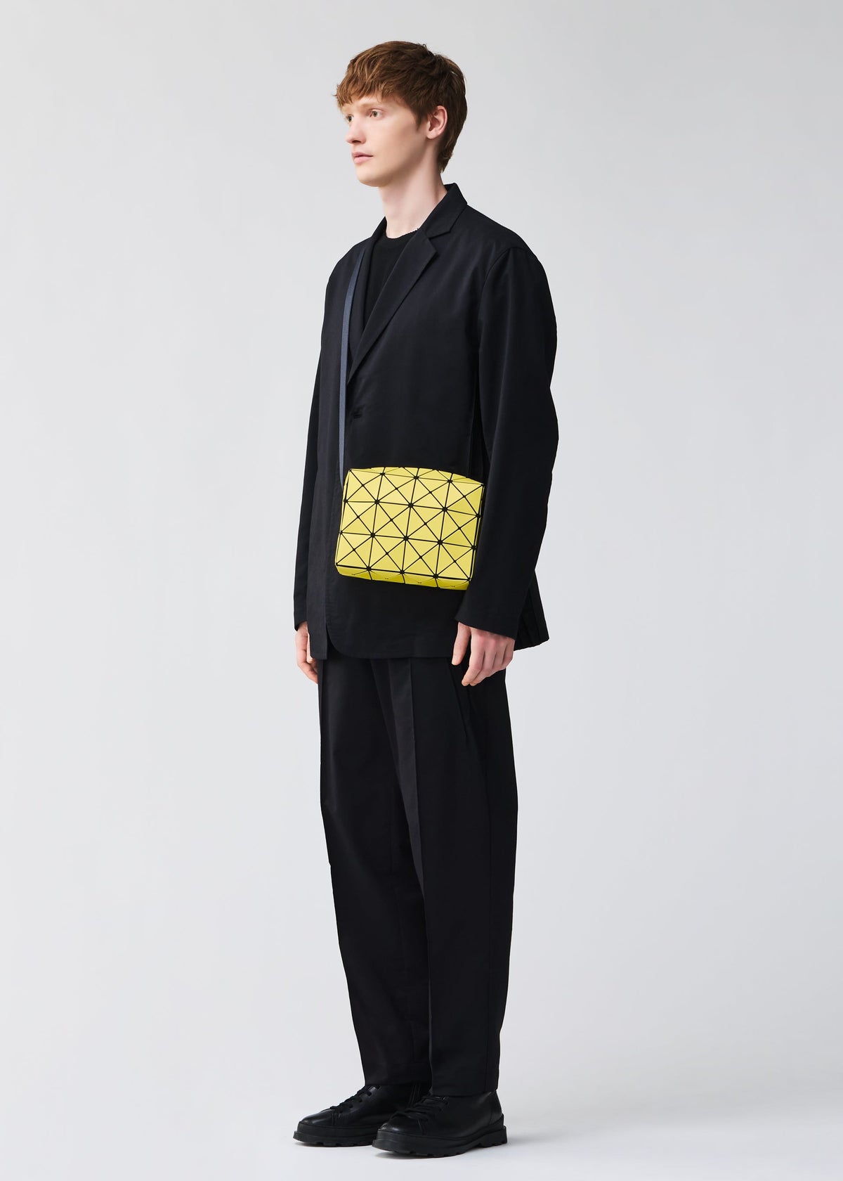 A model wears the BAO BAO ISSEY MIYAKE CUBOID shoulder bag.