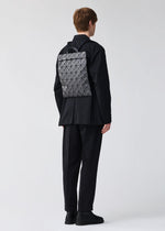 A model wears the BAO BAO ISSEY MIYAKE FLAT PACK backpack.