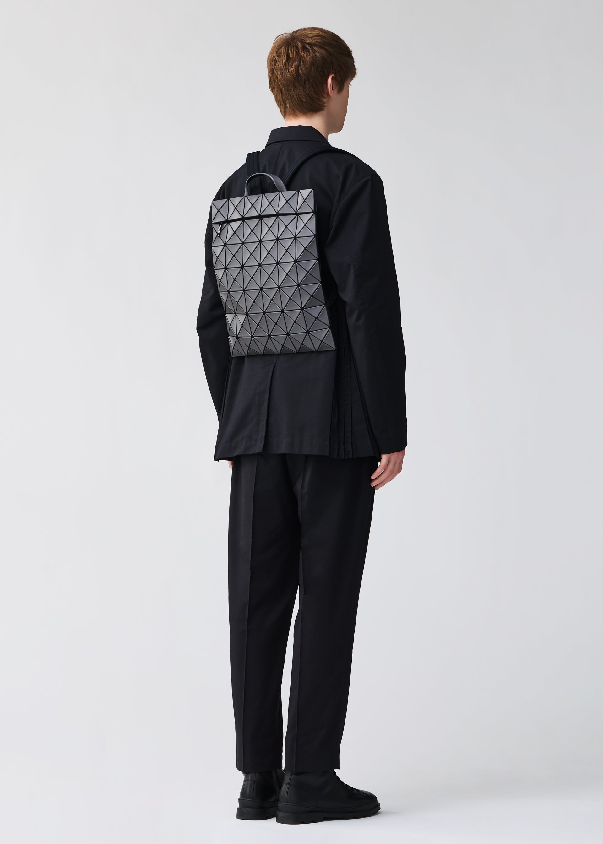 A model wears the BAO BAO ISSEY MIYAKE FLAT PACK backpack.