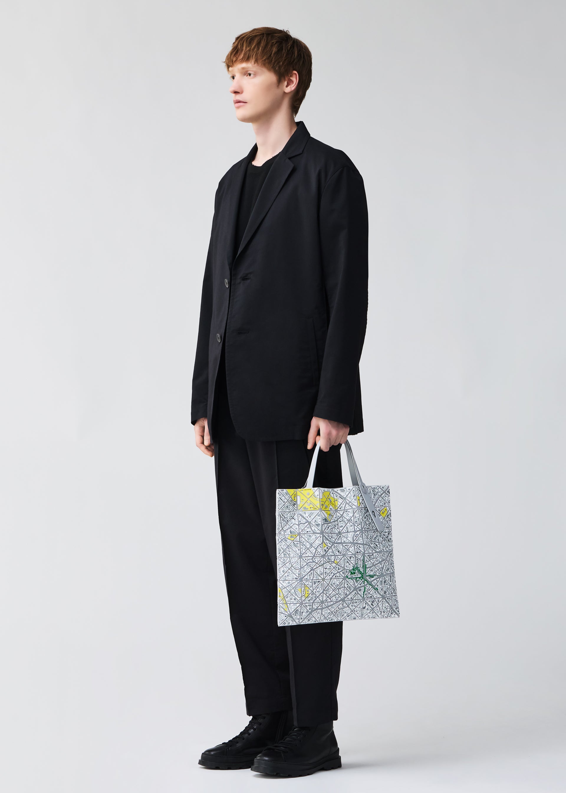 A model wears the BAO BAO ISSEY MIYAKE MAP tote.
