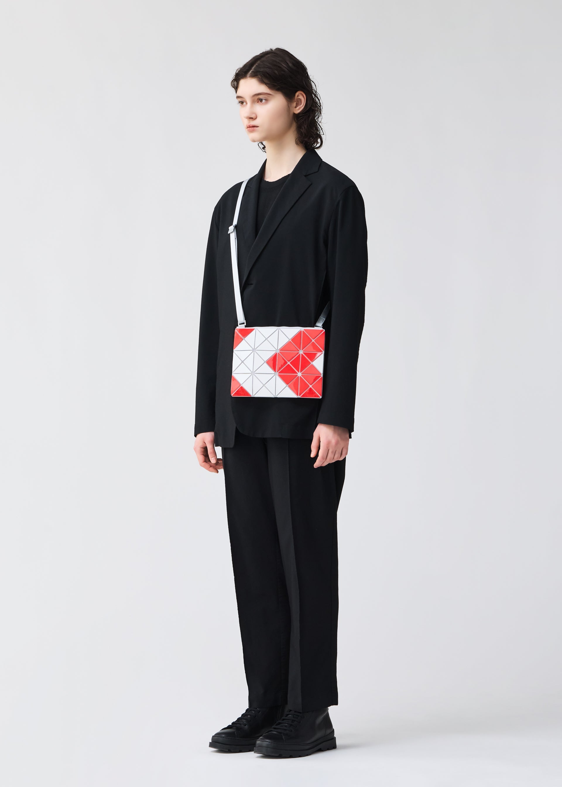 A model wears the BAO BAO ISSEY MIYAKE SIGN shoulder bag.