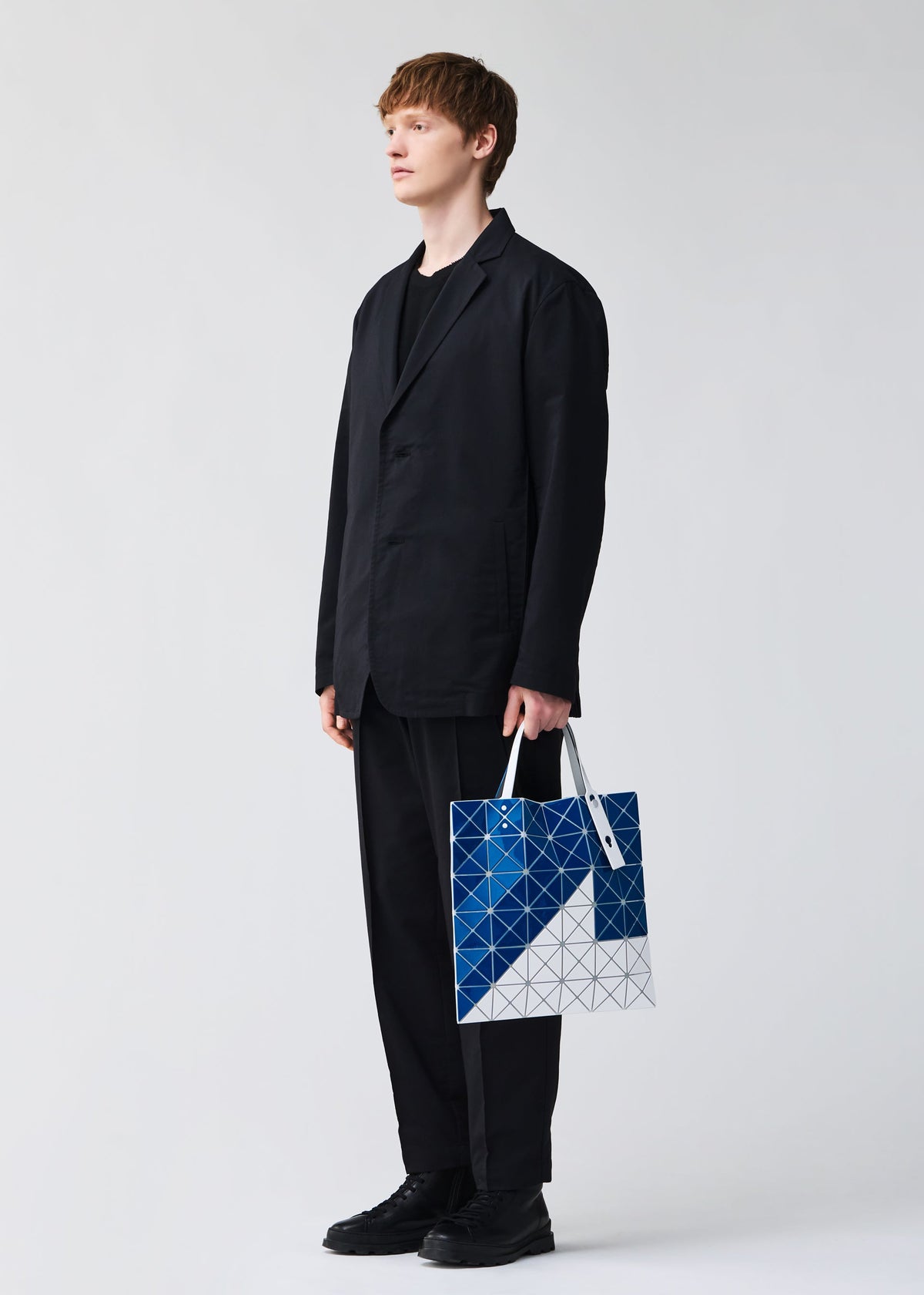 A model wears the BAO BAO ISSEY MIYAKE SIGN tote.